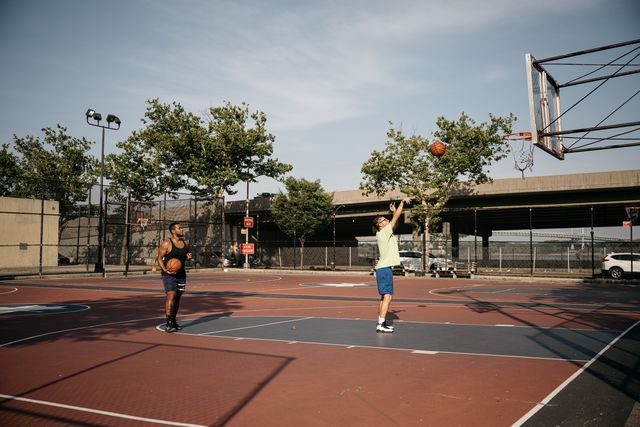New Yorkers shoot hoops at a playground next to FDR Drive in East Harlem. This low-lying area could be at risk from future storms.